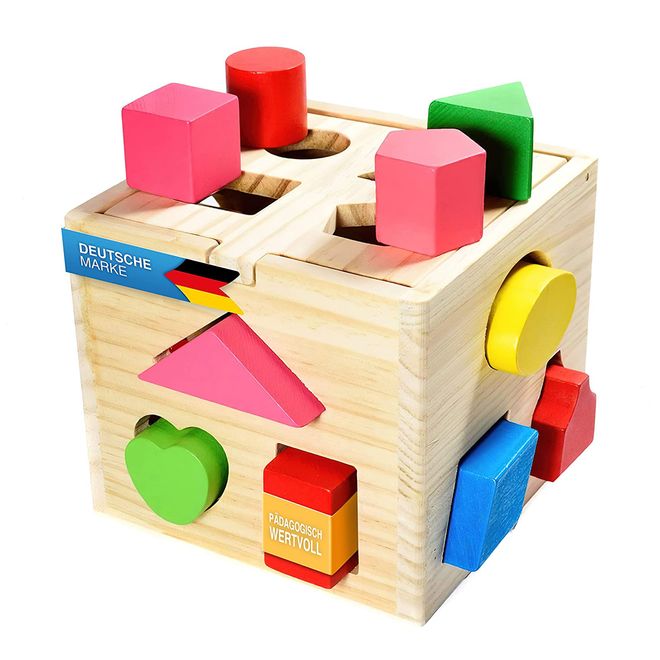 Bild eines Holzwürfel-Kasten mit verschieden geformten Öffnungen für verschiedene Formen.