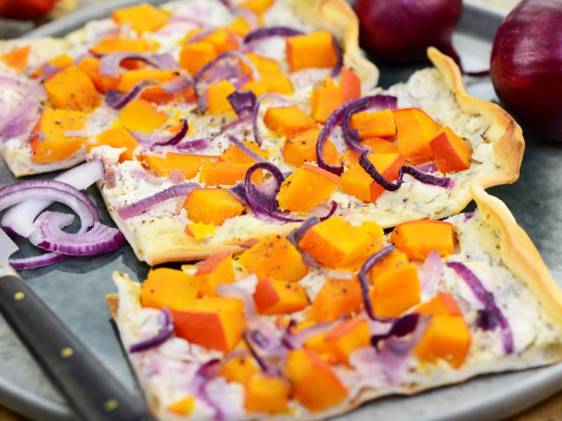 Flammkuchen mit Kürbis und roten Zwiebeln.