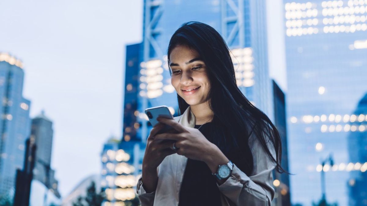 Frau hält Handy in der Hand. 