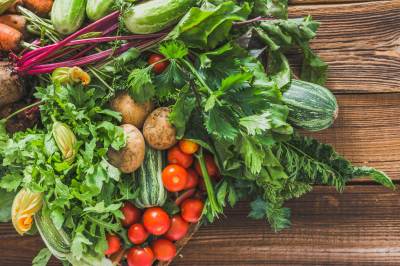 Farm frisches Gemüse auf hölzernen Hintergrund, Draufsicht, Gemüse und geerntete Produkte aus dem Garten