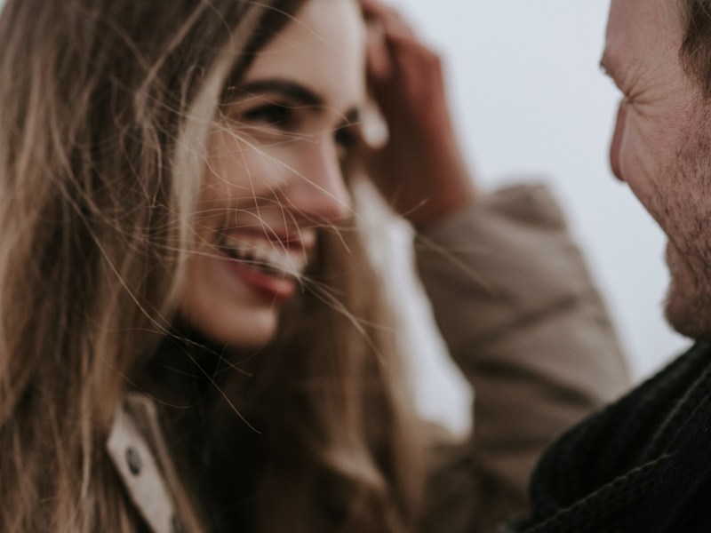 Eine Frau und ein Mann lachen sich verliebt an.