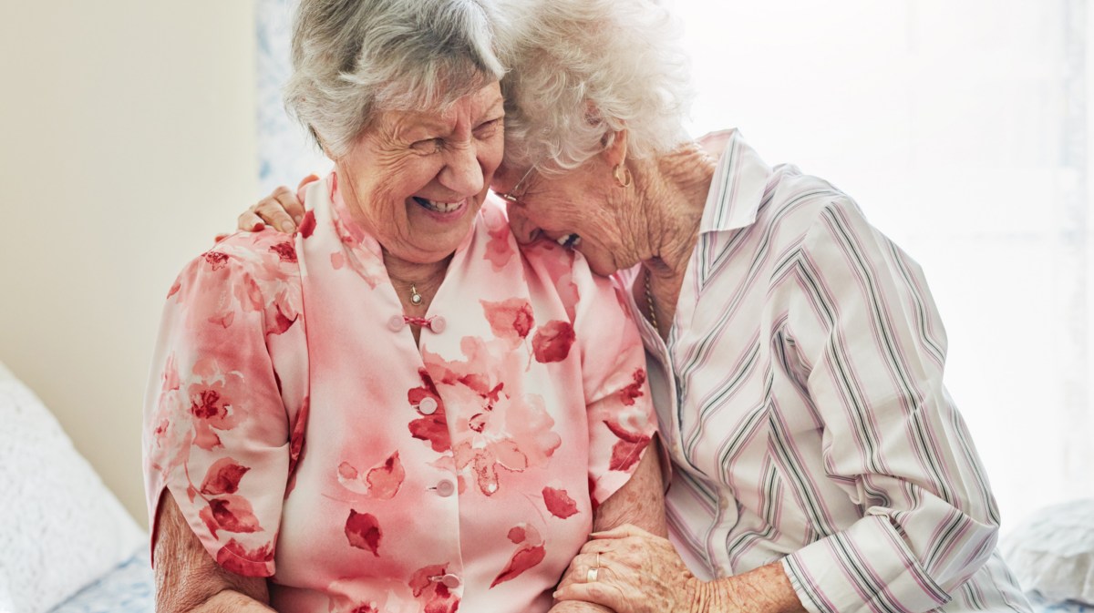 Zwei ältere Frauen lachen zusammen.