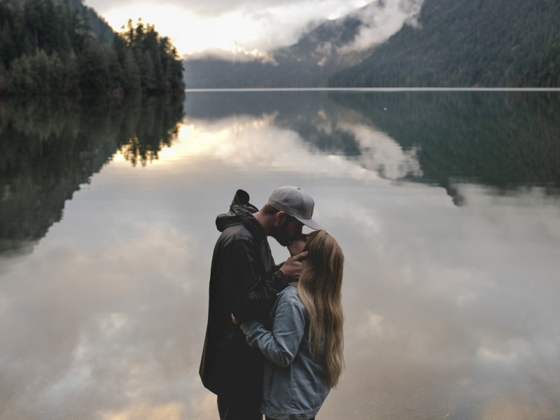 Paar vor einem See, das sich küsst
