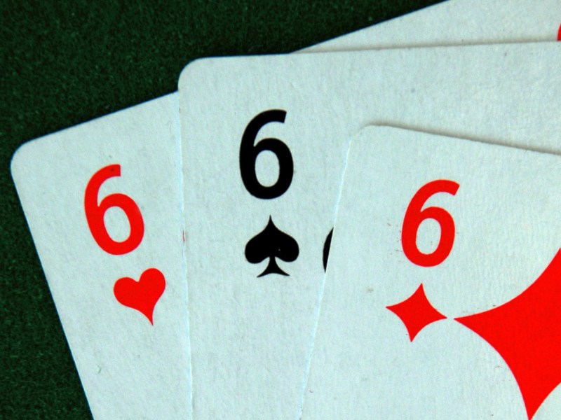 Pokerkarten mit den Nummern 6, 6 und 6