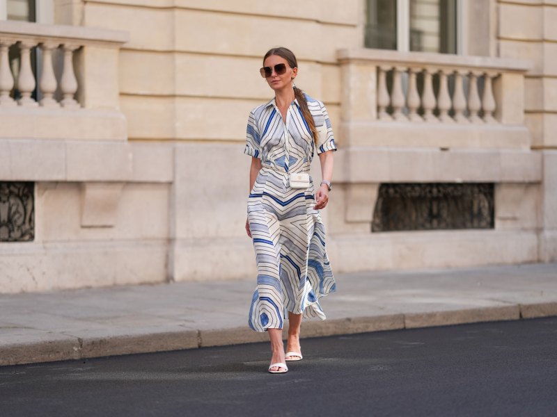 Frau mit einem gemusterten Kleid und Sonnenbrille