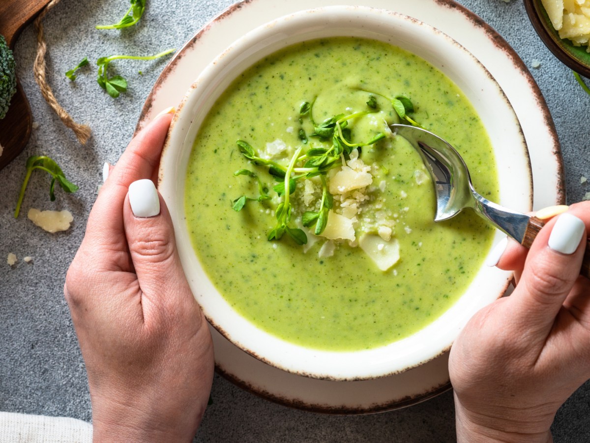 Brokkolisuppe in weißer Schale mit Parmesan.